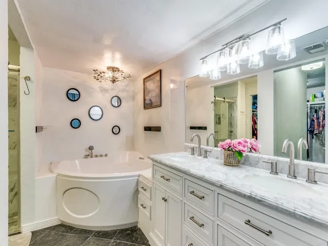 a bathroom with a sink double vanity and a mirror