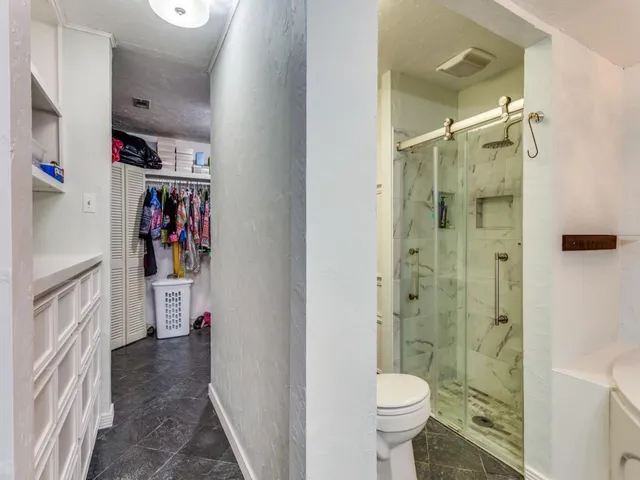 a bathroom with a toilet and a shower