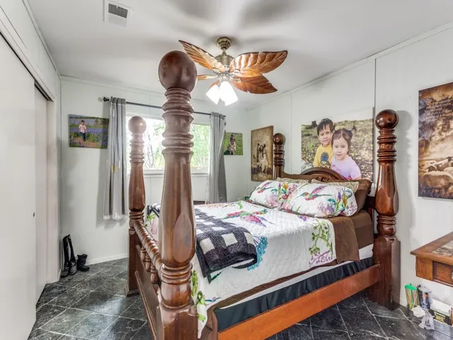 a bedroom with bed and wooden floor