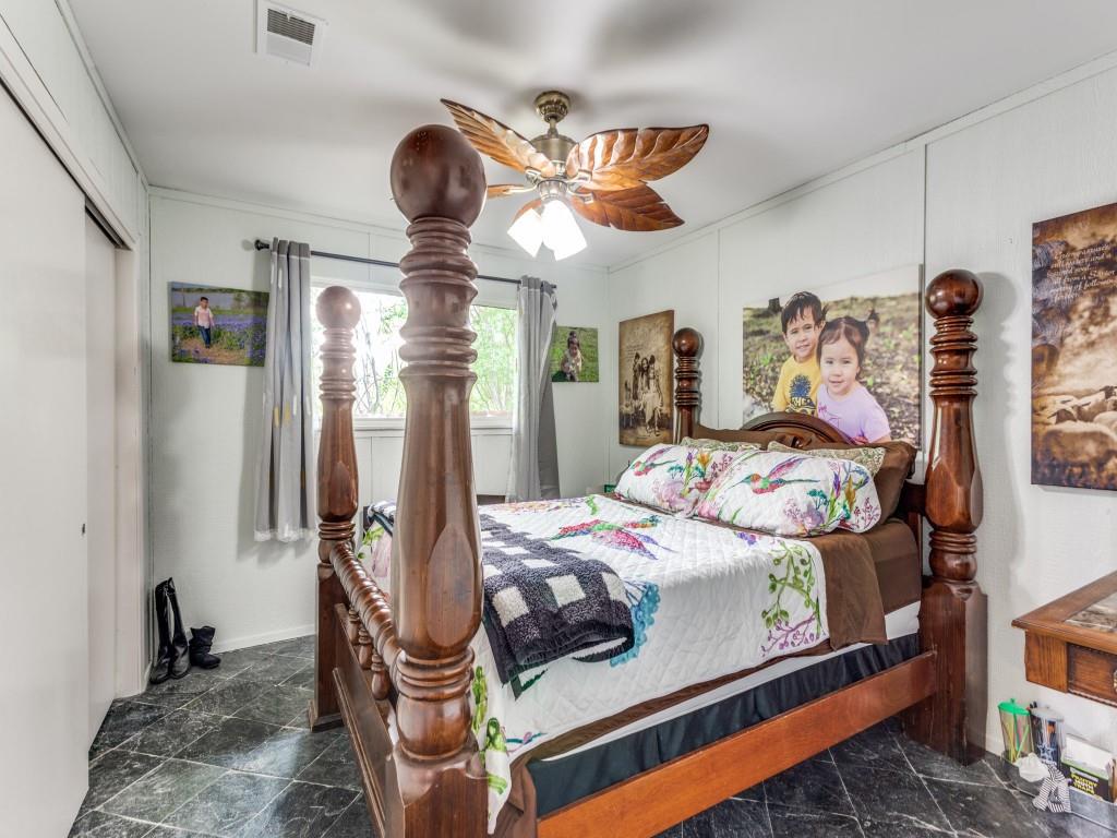 405 Chandler Lake Road Fort Worth, TX 76103 - Photo 13 of 20 a bedroom with bed and wooden floor