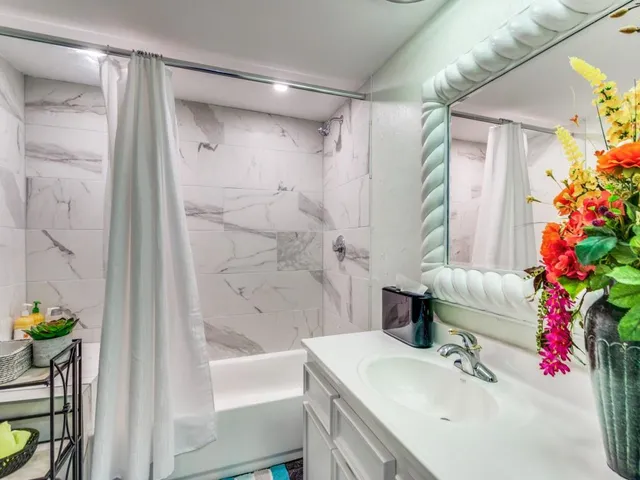 a bathroom with a sink toilet and shower