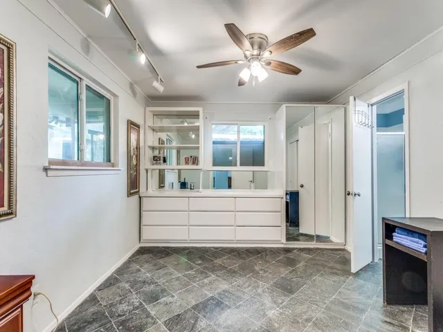 a view of room with window and a ceiling fan