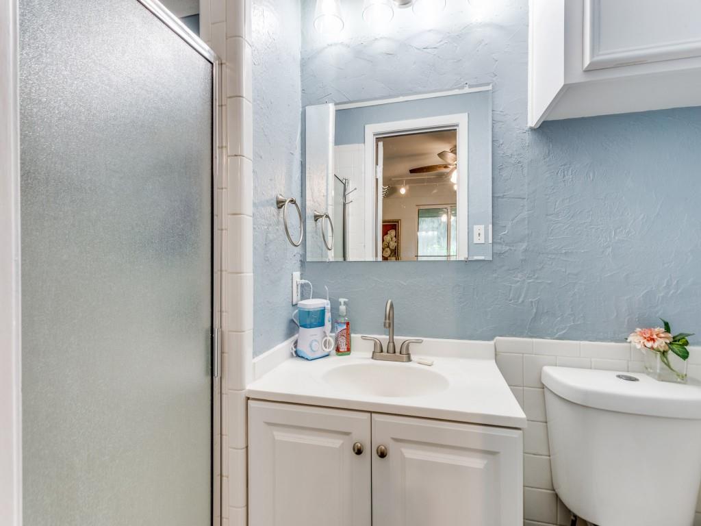 405 Chandler Lake Road Fort Worth, TX 76103 - Photo 17 of 20 a bathroom with a sink and a toilet