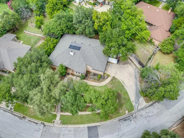 an aerial view of a house with a yard basket ball court and outdoor seating
