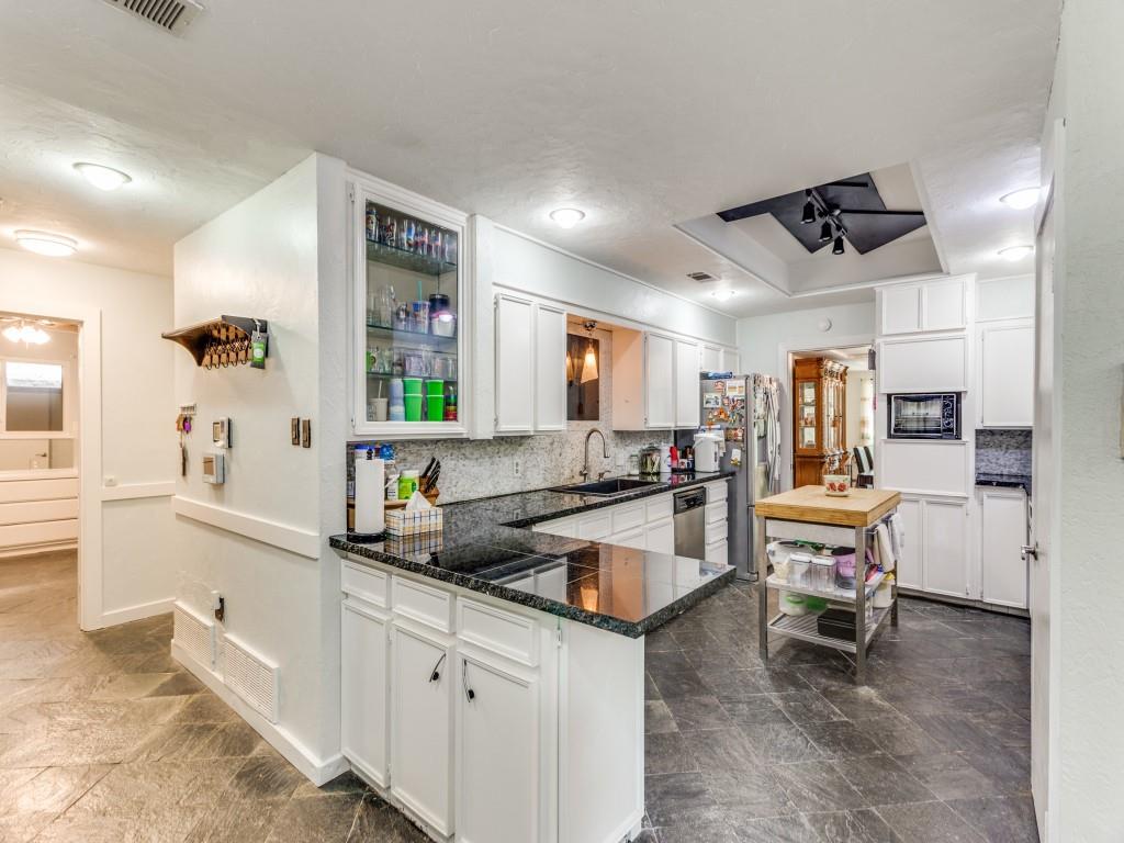 405 Chandler Lake Road Fort Worth, TX 76103 - Photo 5 of 20 a kitchen with a sink stove and chairs
