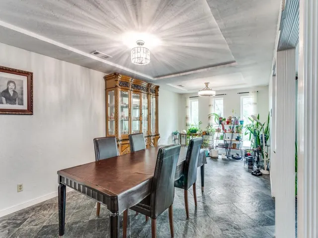 a view of a dining room with furniture and chandelier