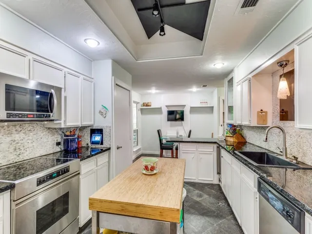 a kitchen with counter top space cabinets and stainless steel appliances