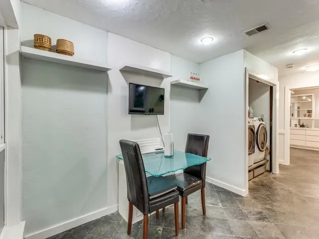 a work room with furniture and a wooden floor
