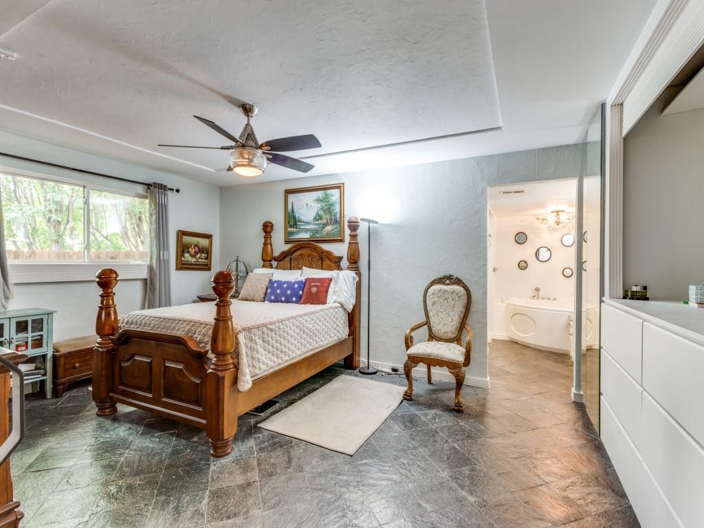 405 Chandler Lake Road Fort Worth, TX 76103 - Photo 10 of 20 a bedroom with a bed and a chandelier