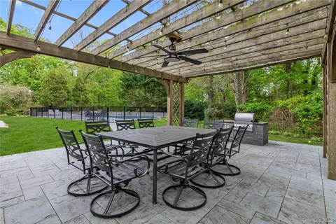 a view of a patio with table and chairs