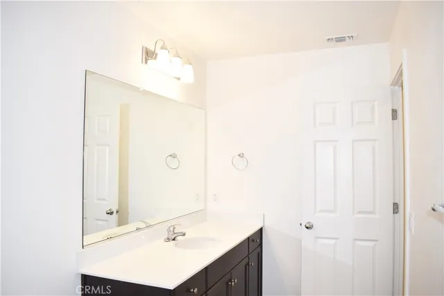 a bathroom with a sink a mirror and a shower