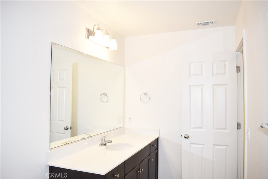 334 Arpent Court Merced, CA 95341 - Photo 5 of 10 a bathroom with a sink a mirror and a shower