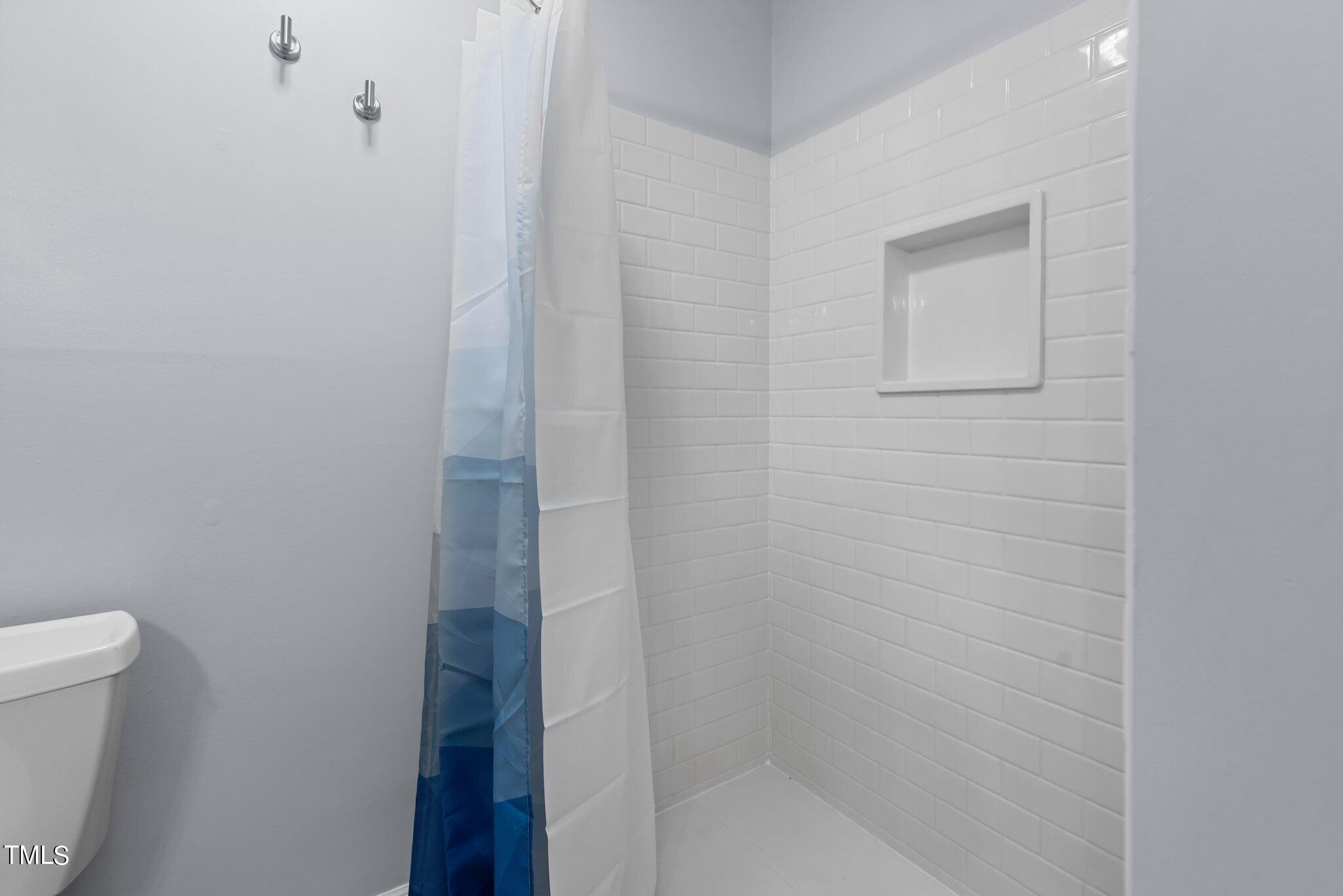 805 Green Ridge Drive Raleigh, NC 27609 - Photo 36 of 57 a bathroom with a bathtub