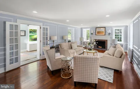 a living room with furniture wooden floor and a fireplace