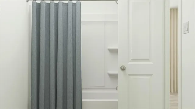 a bathroom with bathtub and shower