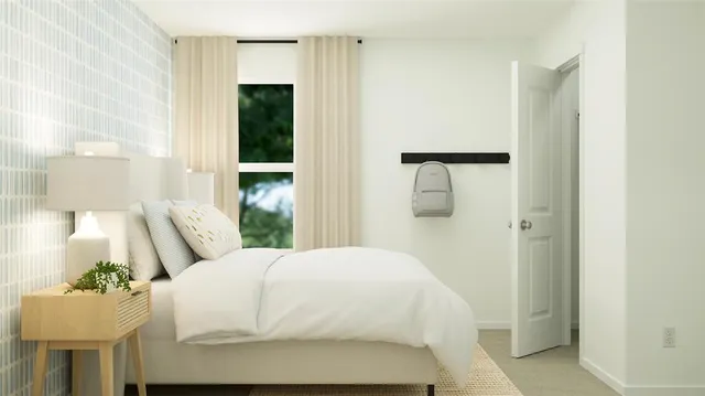 a bedroom with a bed and a painting on the wall