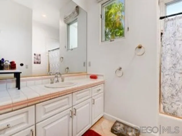 17381 Circa Oriente Rancho Santa Fe, CA 92067 - Photo 17 of 37 a bathroom with a sink and a mirror