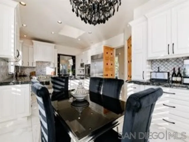 17381 Circa Oriente Rancho Santa Fe, CA 92067 - Photo 22 of 37 a view of kitchen with dining table chairs and refrigerator