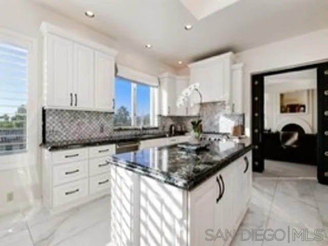 17381 Circa Oriente Rancho Santa Fe, CA 92067 - Photo 8 of 37 a kitchen with granite countertop a sink stove and cabinets