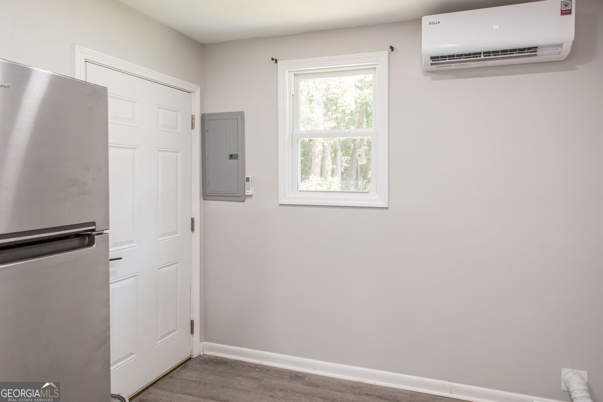2312 Spurgeon Street Waycross, GA 31501 - Photo 11 of 20 a view of an empty room with wooden floor and a window