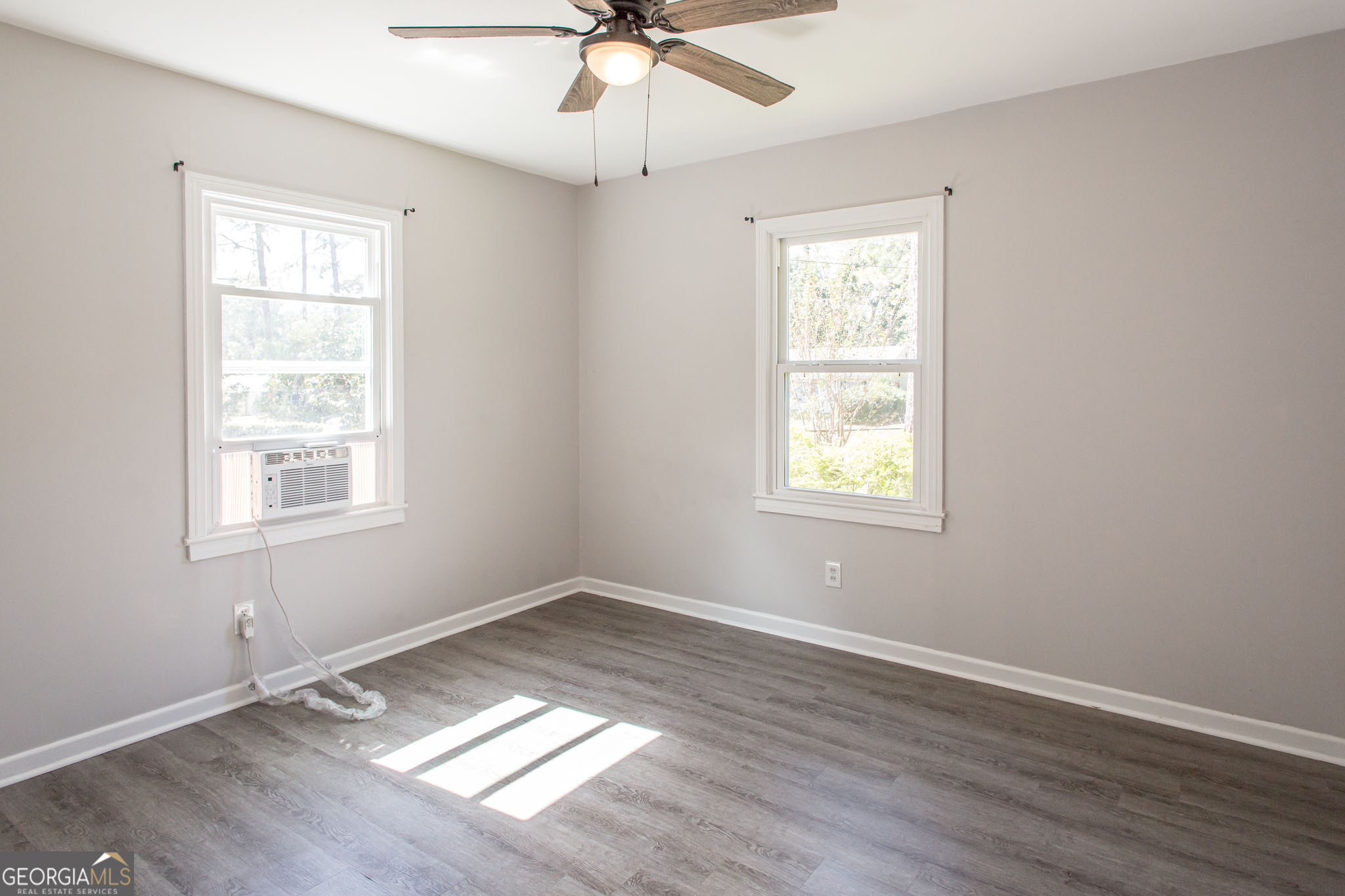 2312 Spurgeon Street Waycross, GA 31501 - Photo 14 of 20 a view of an empty room with wooden floor and a window