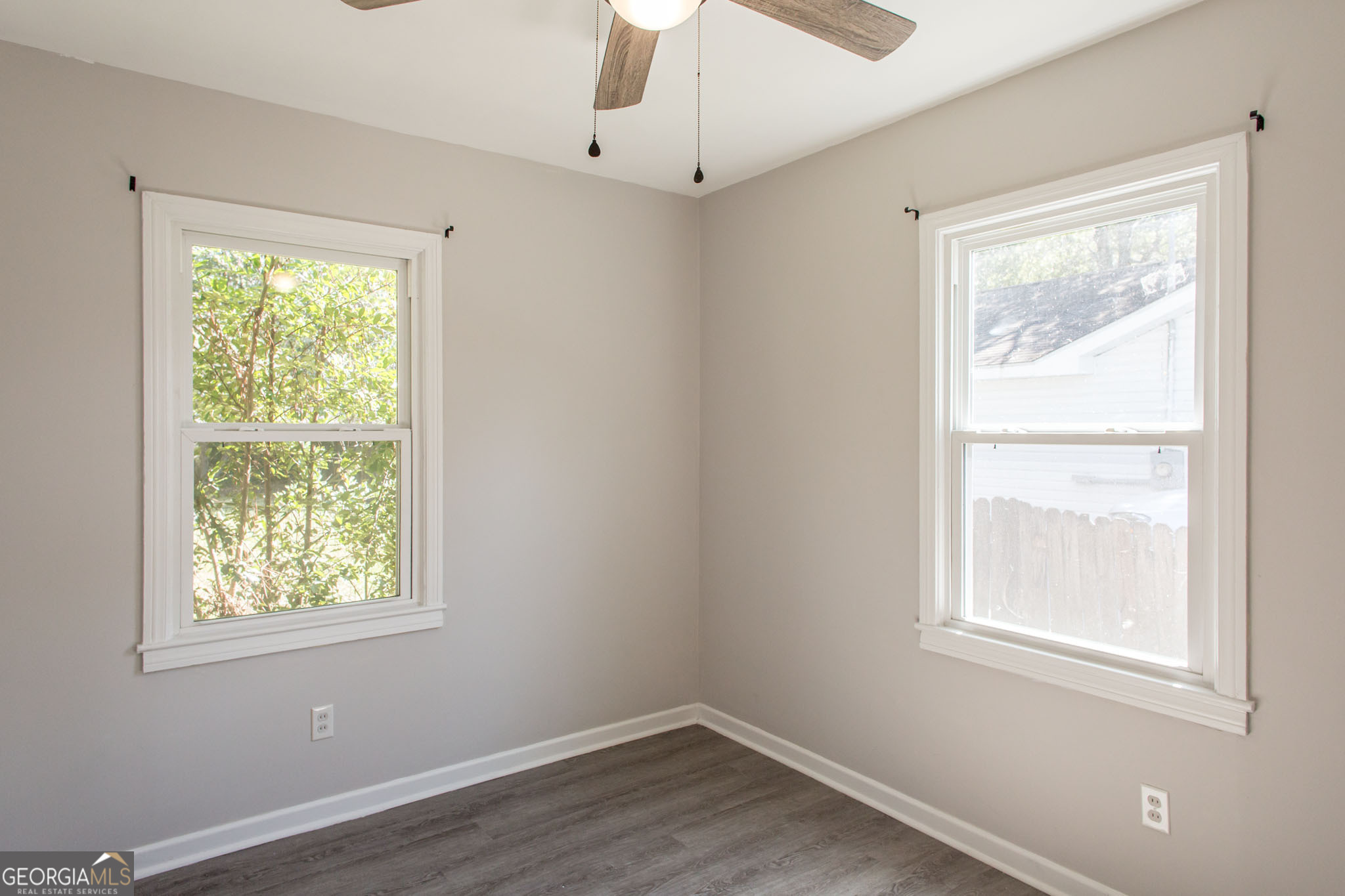 2312 Spurgeon Street Waycross, GA 31501 - Photo 16 of 20 a view of an empty room with wooden floor and a window