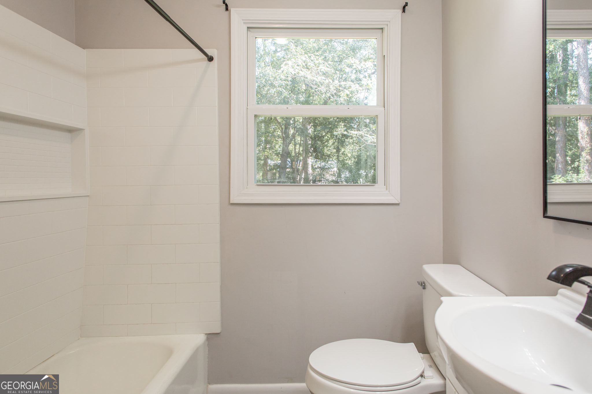 2312 Spurgeon Street Waycross, GA 31501 - Photo 17 of 20 a white toilet sitting next to a bath tub