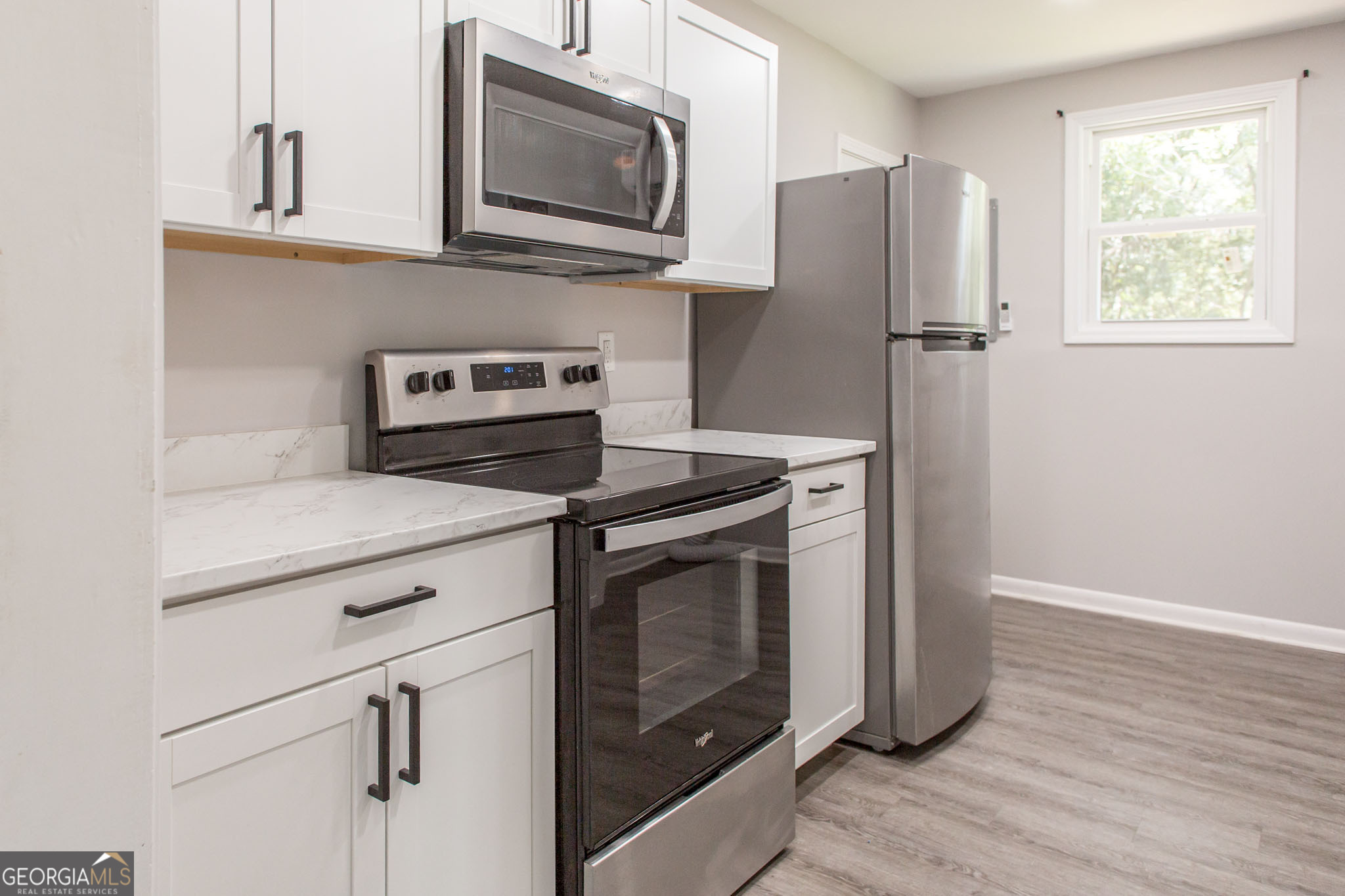 2312 Spurgeon Street Waycross, GA 31501 - Photo 8 of 20 a kitchen with a stove microwave and refrigerator