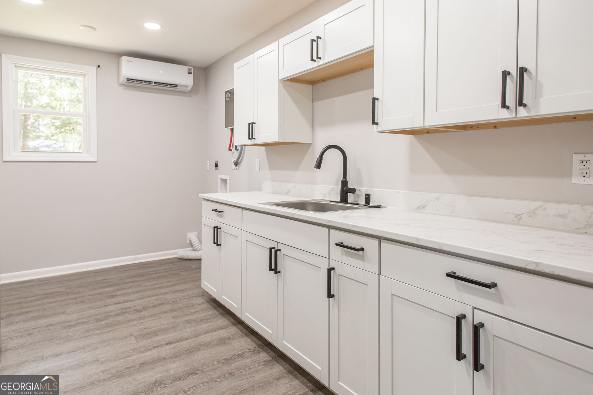 2312 Spurgeon Street Waycross, GA 31501 - Photo 10 of 20 a white kitchen with sink and cabinets