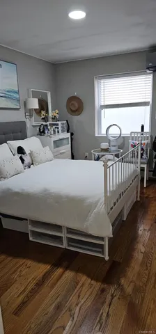 a kitchen with stainless steel appliances granite countertop a refrigerator a stove and a sink with wooden floor