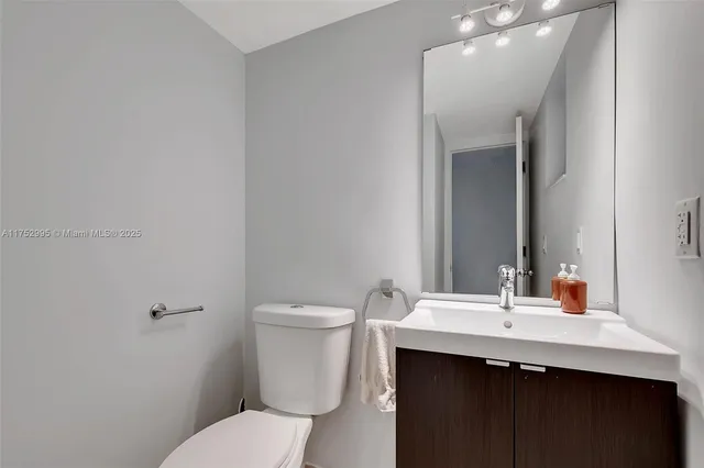 a bathroom with a sink toilet and mirror