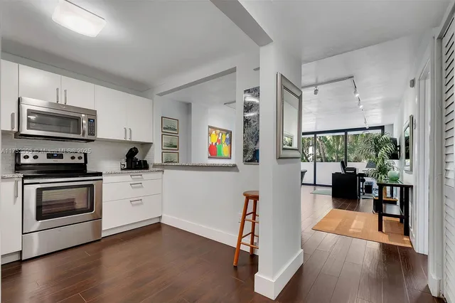 a kitchen with stainless steel appliances a stove a sink and a refrigerator