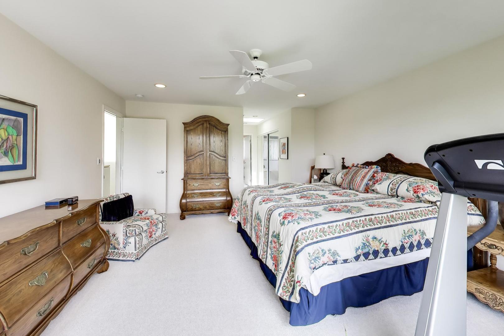 495 Milford Road Deerfield, IL 60015 - Photo 15 of 33 a spacious bedroom with a bed and a chandelier