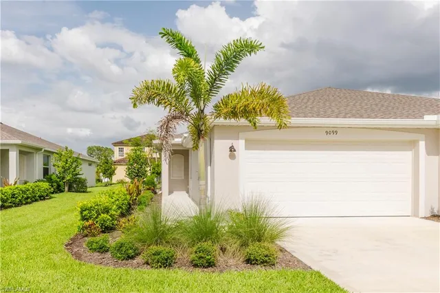 a front view of a house with a yard garage and outdoor seating