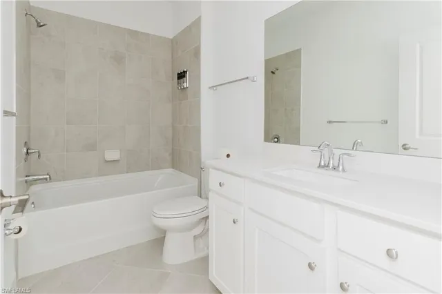 a bathroom with a bathtub shower sink mirror and toilet