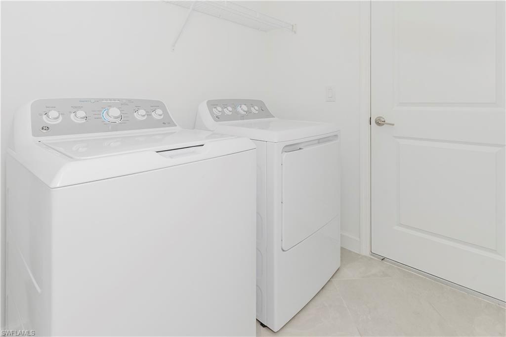 9099 Leatherwood Loop Lehigh Acres, FL 33936 - Photo 20 of 30 a utility room with dryer and washer