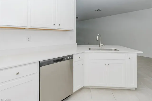 a utility room with cabinets washer and dryer