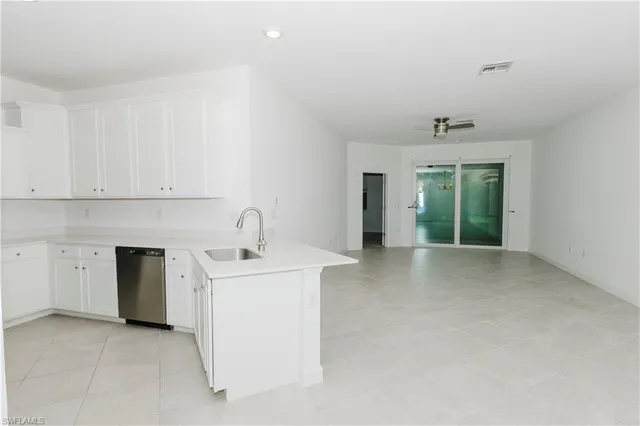 a view of a kitchen with a sink stove and cabinets