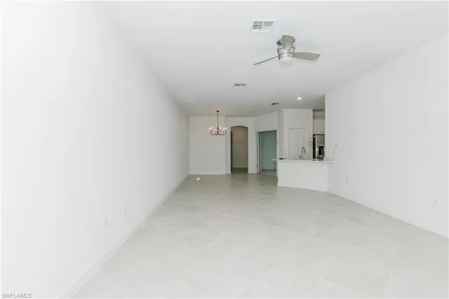 a view of a room with ceiling fan and window