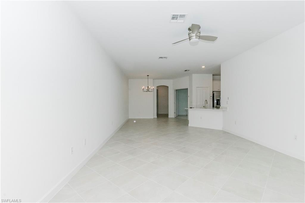 9099 Leatherwood Loop Lehigh Acres, FL 33936 - Photo 6 of 30 a view of a room with ceiling fan and window