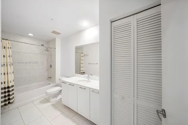 a bathroom with a toilet a sink and bathtub
