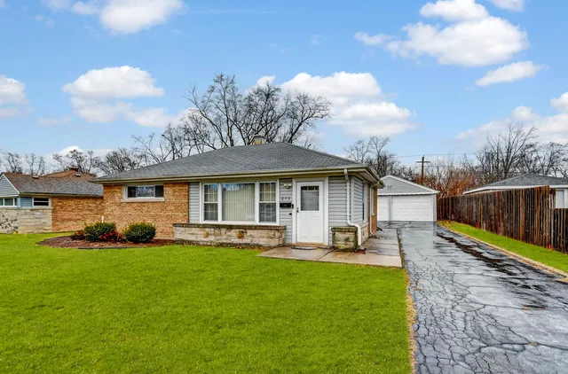 a front view of a house with a yard patio and fire pit