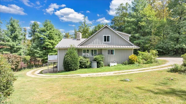 a view of an entryway with wooden floor and livingroom