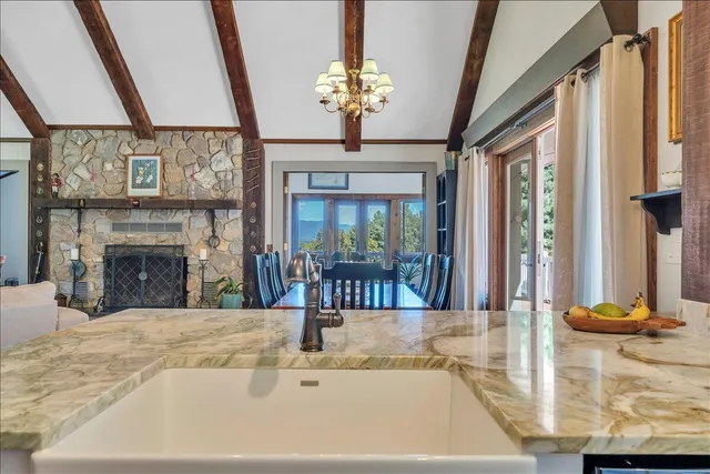a living room with furniture large window and a fireplace