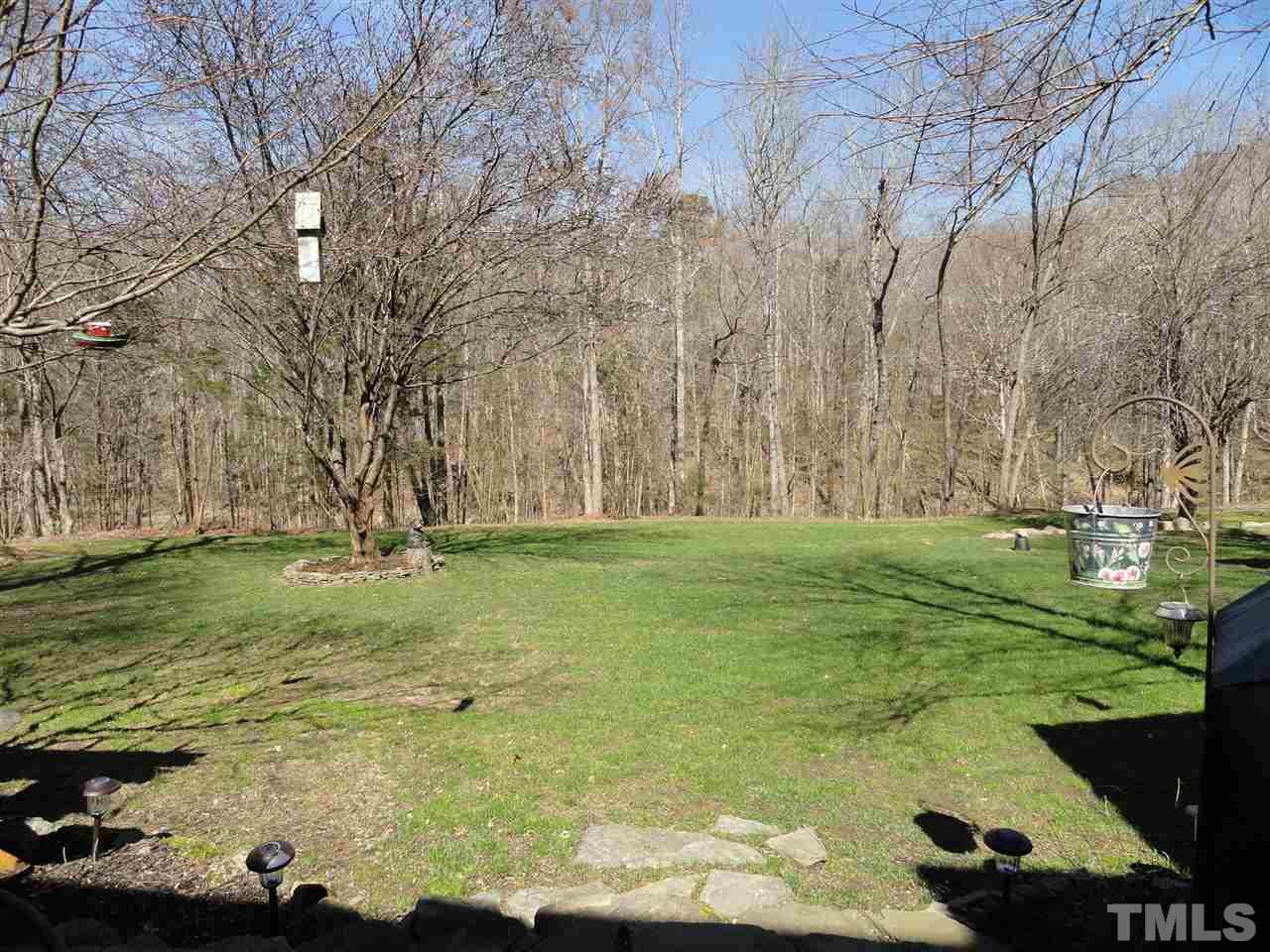 3520 Ribcowski Court Raleigh, NC 27616 - Photo 22 of 25 a backyard of a house with lots of green space