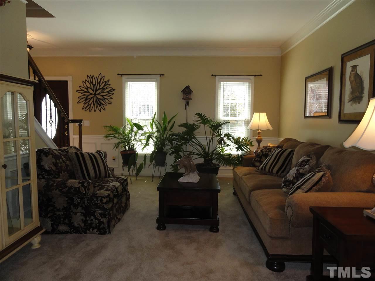 3520 Ribcowski Court Raleigh, NC 27616 - Photo 5 of 25 a living room with furniture and a potted plant