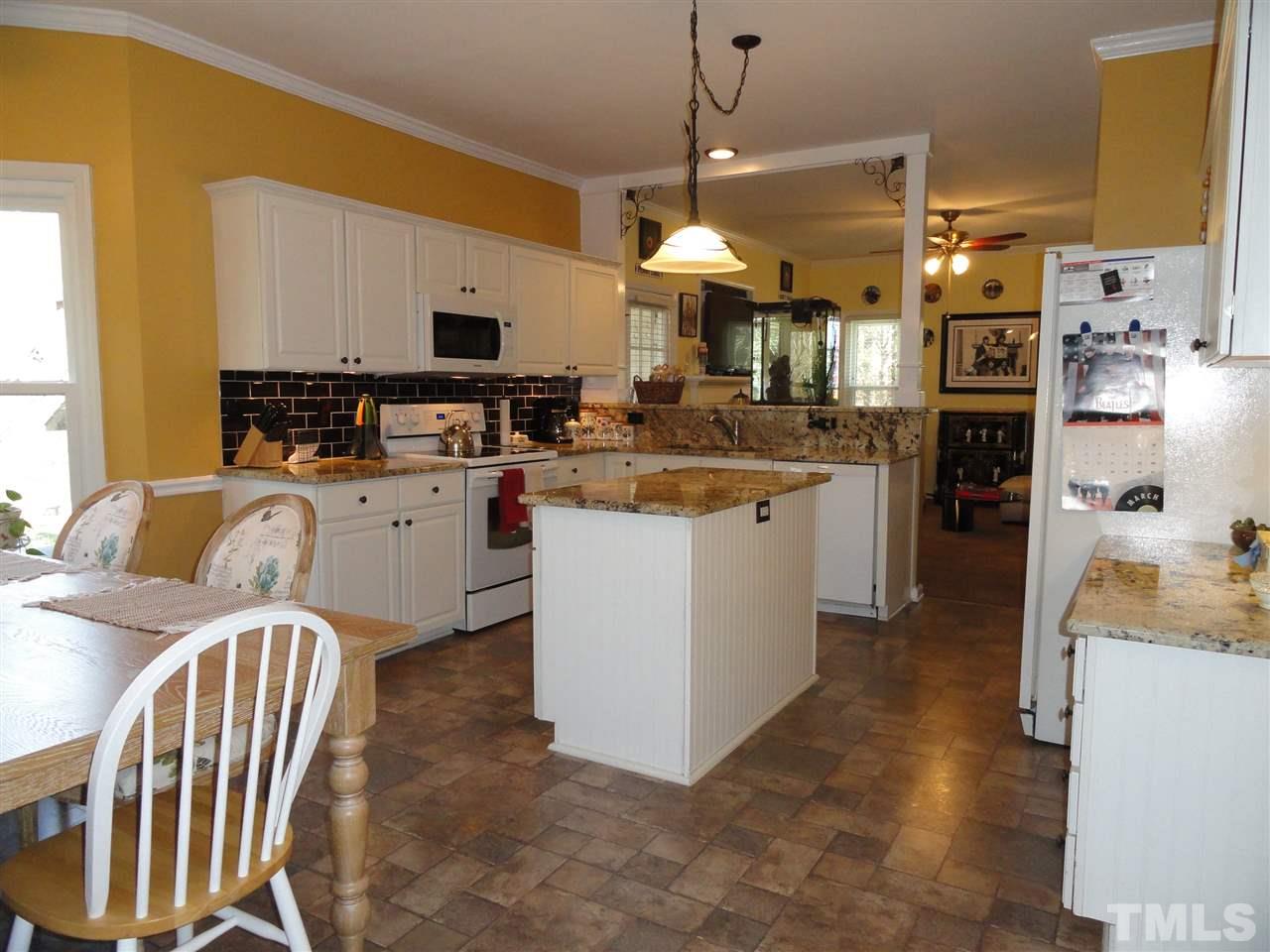 3520 Ribcowski Court Raleigh, NC 27616 - Photo 8 of 25 a kitchen that has a lot of white cabinets a sink and stainless steel appliances