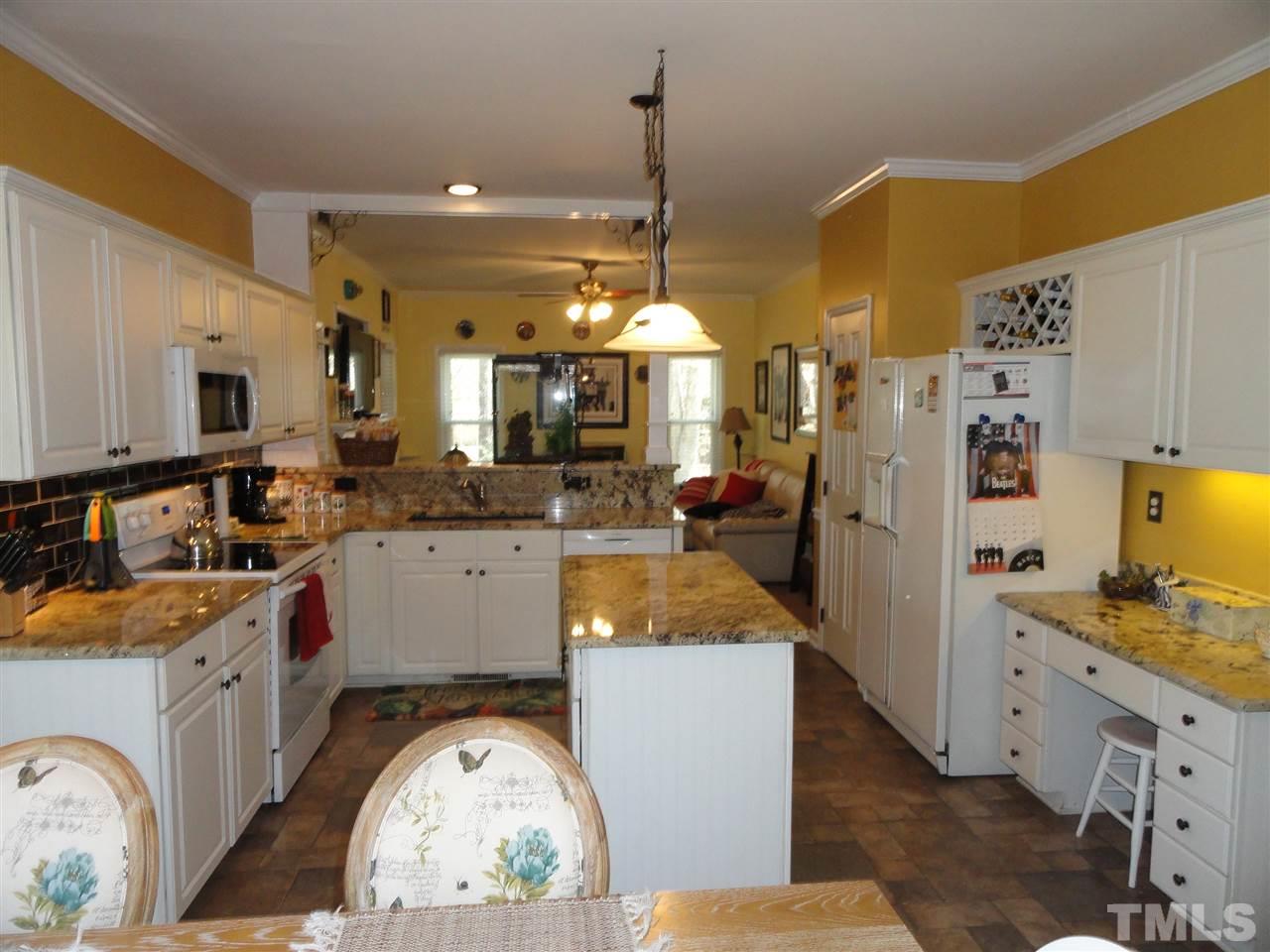 3520 Ribcowski Court Raleigh, NC 27616 - Photo 9 of 25 a very nice looking open kitchen with stainless steel appliances granite countertop a stove a sink a refrigerator and a microwave