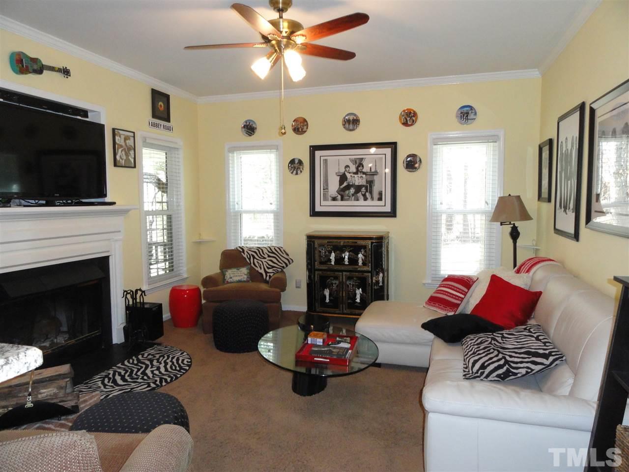 3520 Ribcowski Court Raleigh, NC 27616 - Photo 10 of 25 a living room with furniture a flat screen tv and a fireplace