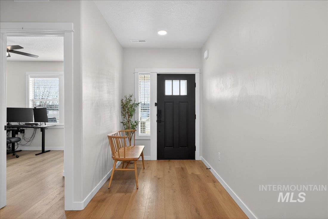 1993 North Perth Court Middleton, ID 83644 - Photo 11 of 45 Entrance foyer with healthy amount of natural light, light wood-style flooring, and a textured ceiling